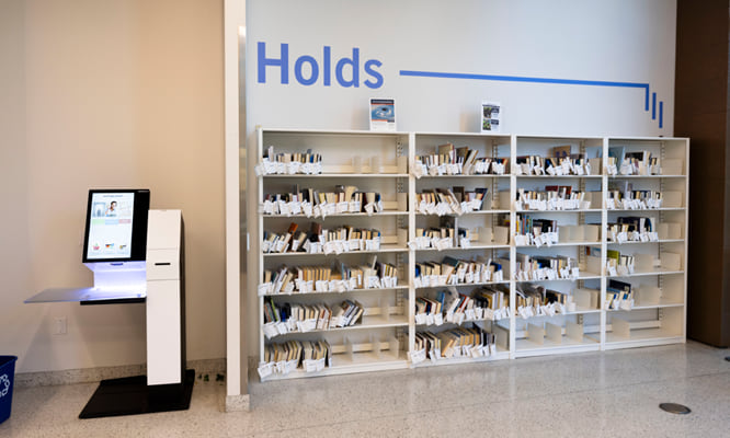 A bookshelf containing holds for Maricopa County Library District customers.